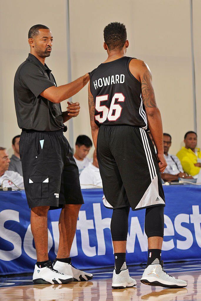 Coach Juwan Howard of the Miami Heat talks to Juwan Howard Jr. #56 of the Miami Heat during the game against the New York Knicks.