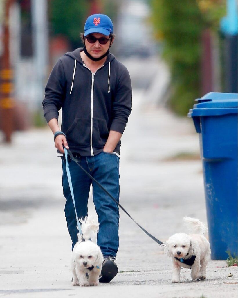 Jonathan Taylor Thomas walking his two Bichon Frise